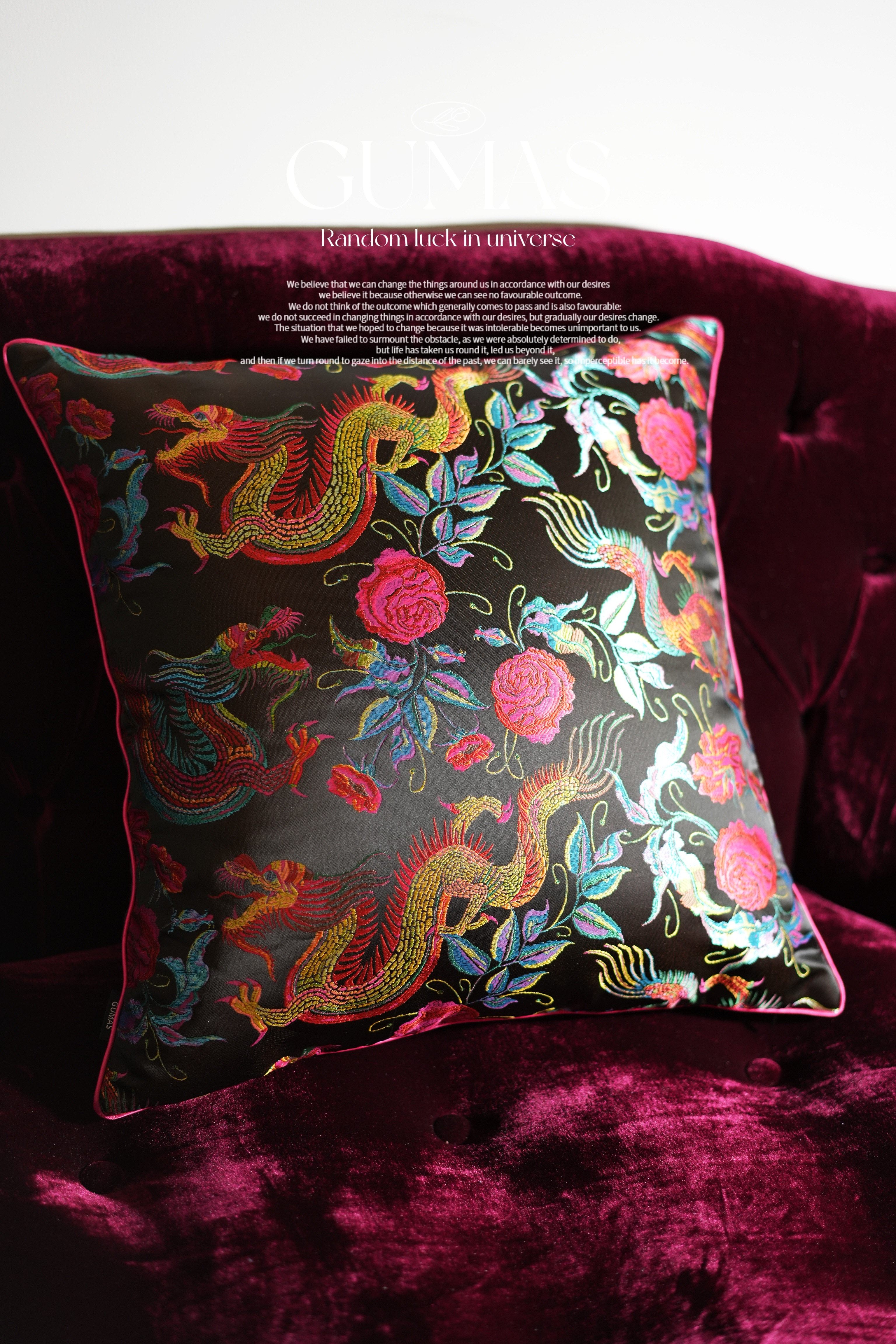 Asian-inspired burgundy velvet pillow with ornamental scrollwork and floral embroidery