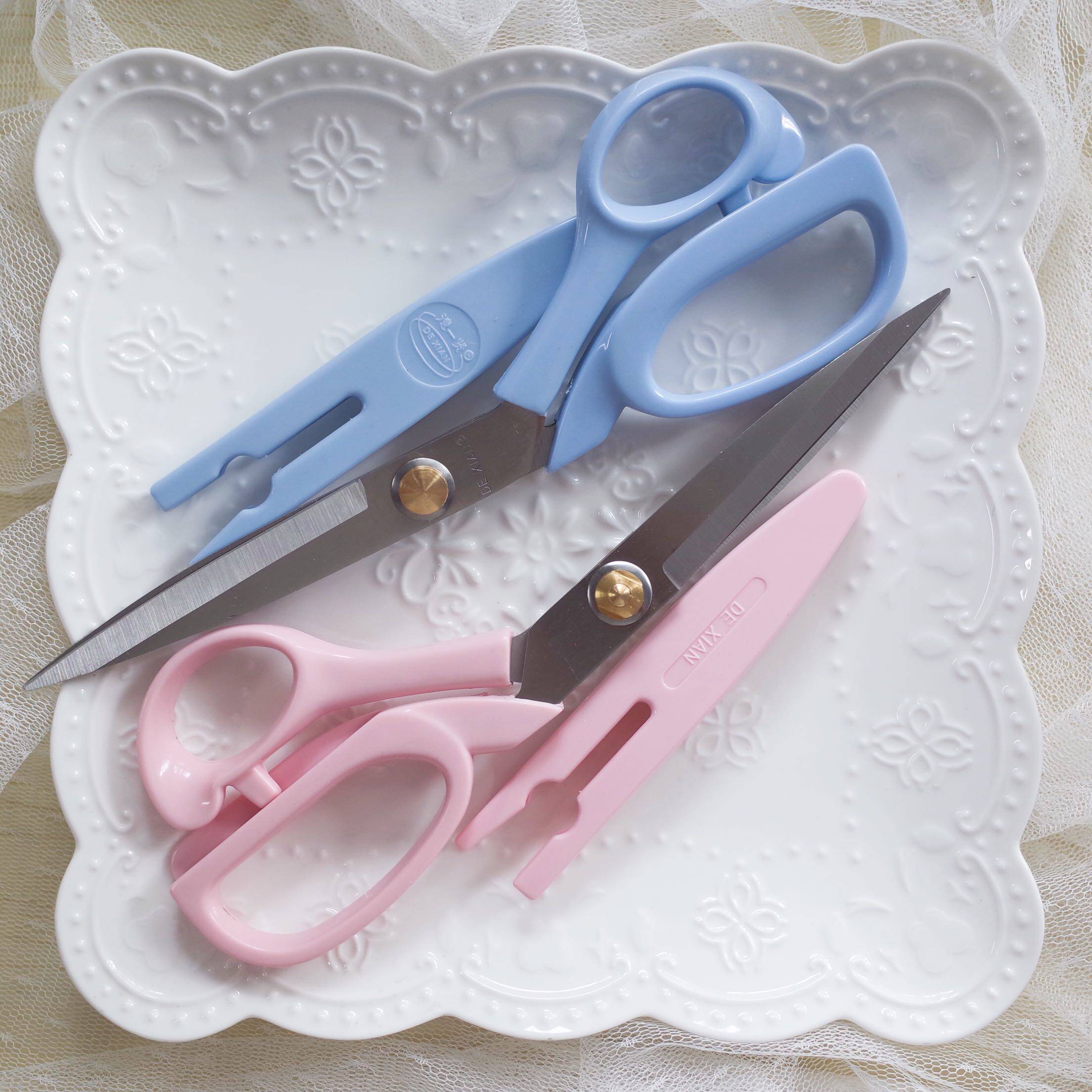 A pair of lightweight 8-inch stainless steel tailor scissors with plastic protective cover weighing about 81g