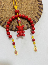 Designed with high cinnabar content the bear is paired with a small fish painted with lotus flowers for good luck. It weighs about 37 grams.