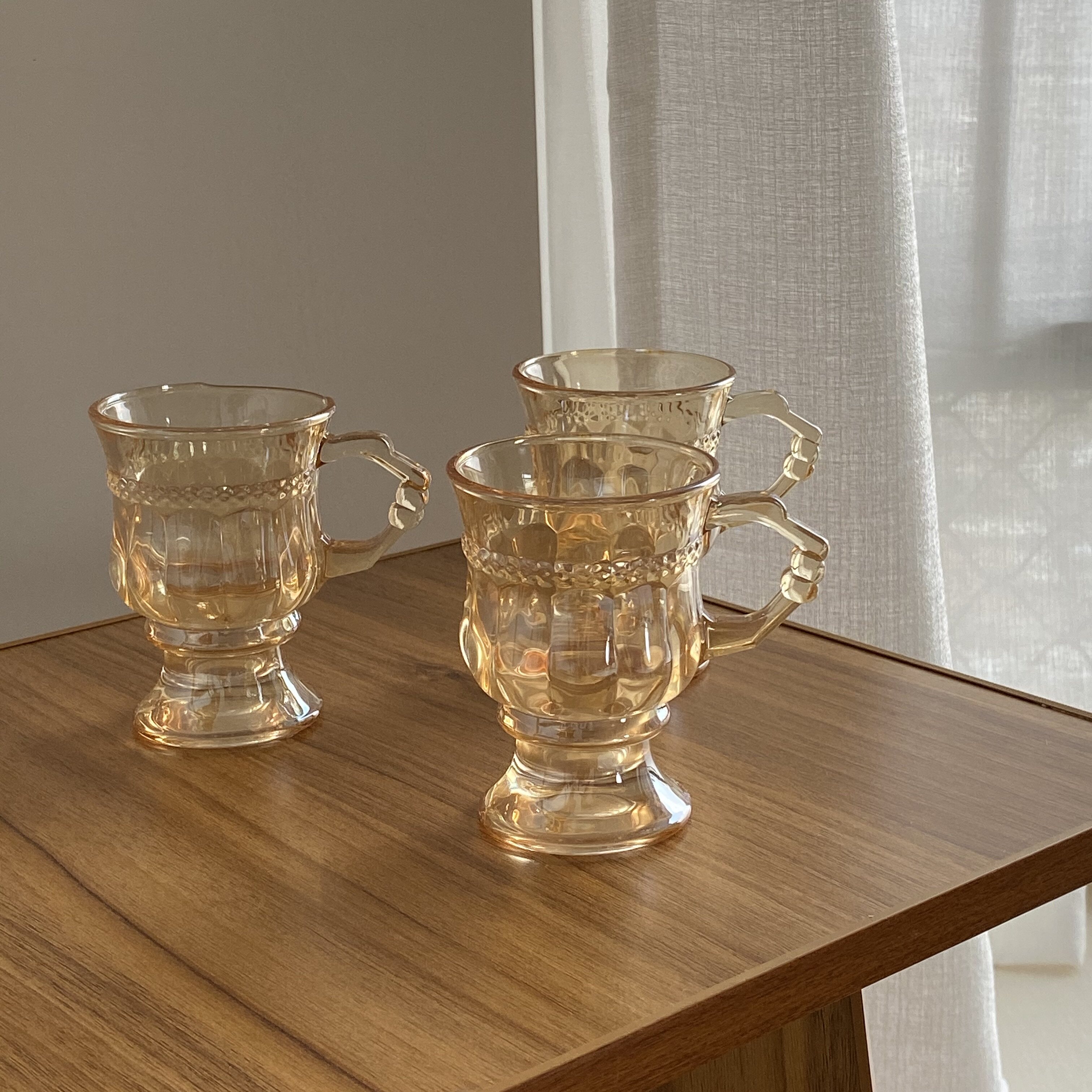 Lua A vintage glass of amber glass glowing on the lake in autumn