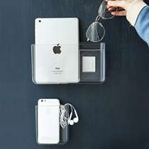 The non-perforated wall-mounted dormitory patch remote control on the wall of the mobile phone storage box at the head of the bed is glued to