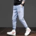 Quần jeans nam 9 điểm màu xanh nhạt phiên bản Hàn Quốc của quần Slim Quần nam hợp thời trang Quần Harem Quần nam - Quần jean Quần jean