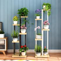 Bonsai plants next to the indoor TV cabinet next to the small potted flower shelf flower shop decoration iron frame background wall mini