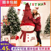 Christmas paparazzi Grand theme Mercy Decorations on the doorstep of the Ornament Store Doorway with a large Christmas Tree Lower Snow Man