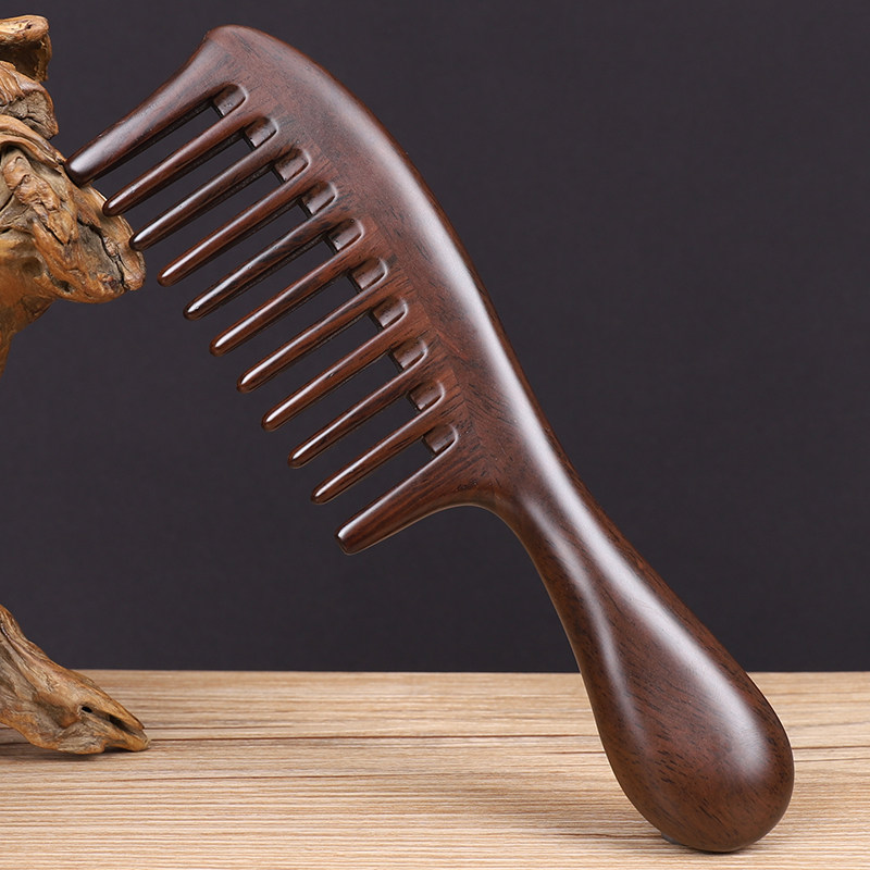 The large-toothed ebony wood comb is made of natural solid wood and is ...