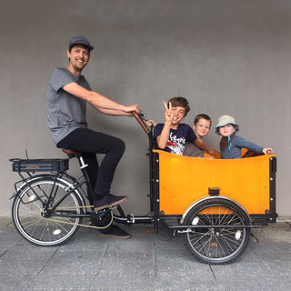 Human-powered wooden tricycle for carrying cargo and picking up children