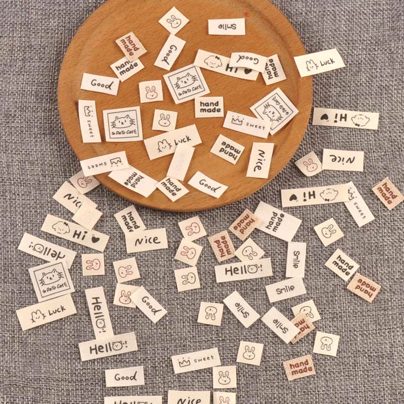 DIY用ベージュの衣類ラベル、衣類タグ、折り畳み布パッチ（100枚入り）