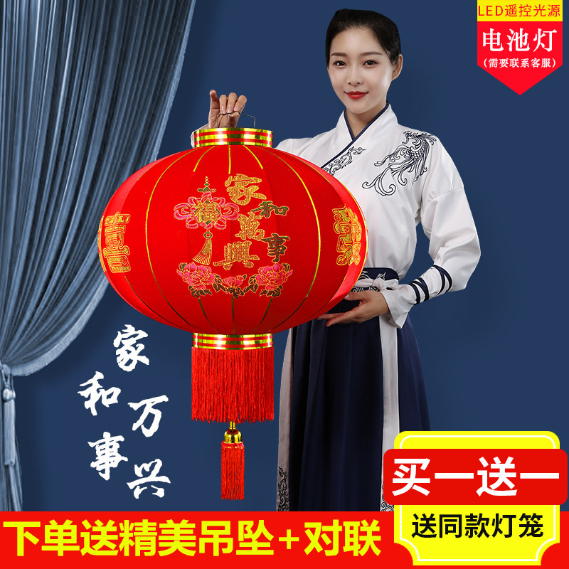 A pair of big red flocked palace lanterns hang the Spring Festival outdoor gate balcony decorated with new Chinese style chandeliers