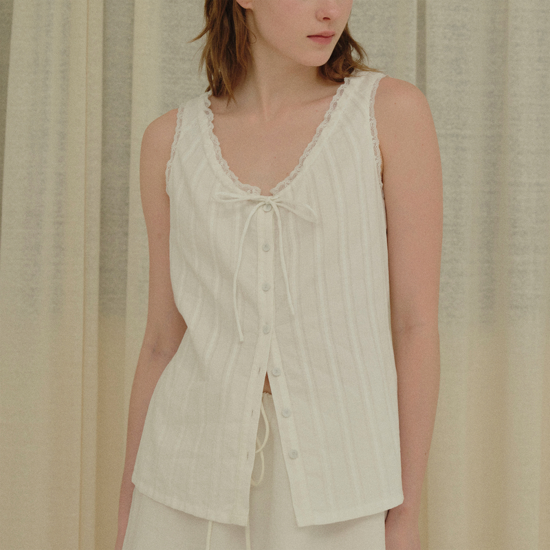 Bowtiful Pure Cotton Textured White Sleeveless Top with Lace Trim, V-Neck, and Tie-Back Bow Bowtiful Pure Cotton Textured White Sleeveless Top with Lace Trim, V-Neck, and Tie-Back Bow