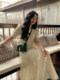 Ren Xiaoyi ຝຣັ່ງ retro hollow dress ການອອກແບບຂອງແມ່ຍິງ off-white skirt ຍາວແອວສູງ embroidered hem skirt ຂະຫນາດໃຫຍ່