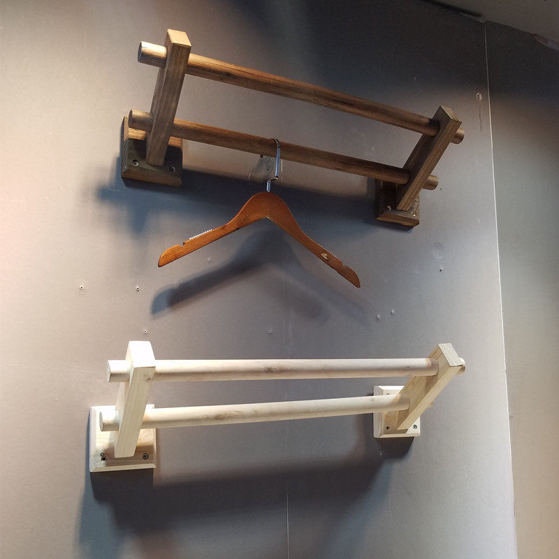 Clothing store display racks are hanging double poles on the wall selling clothes racks Women's clothing store shelves children's clothing retro clothing racks