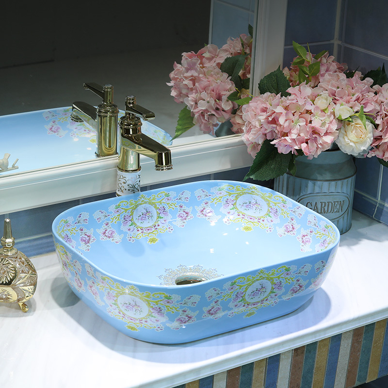 Gold cellnique contracted on the blue square lavatory basin of modern European art ceramic toilet basin that wash a face