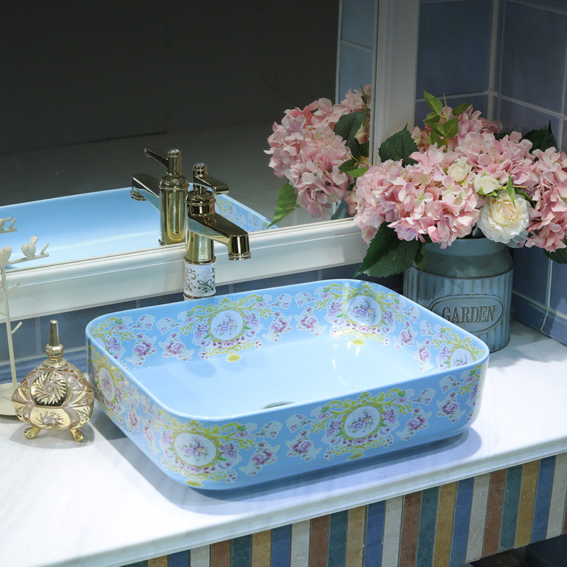 Gold cellnique contracted on the blue square lavatory basin of modern European art ceramic toilet basin that wash a face
