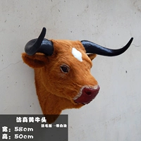 Желтоголовая корова с белыми пятнами — вариант из искусственной шерсти.