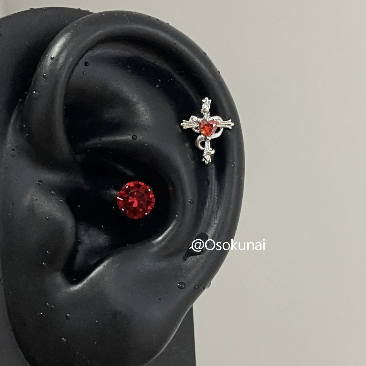 Red snake entwined with a cross heart-shaped ear stud earring, a sweet and cool niche design flat stud earring.