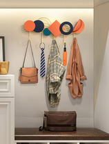 Creative punch-free porch hook into the door wall to include decorated light luxury entry door behind the clothes hook hanging clothes