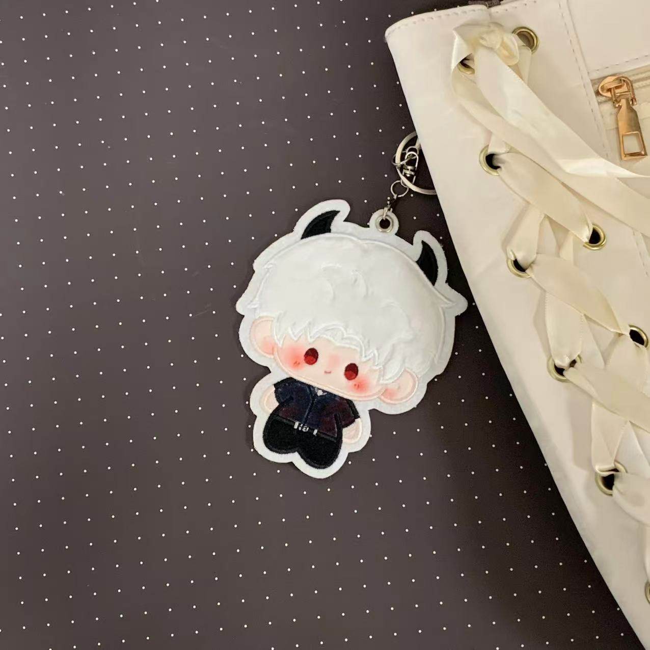 Fan-made Sylus embroidered plush charm attached to a bag