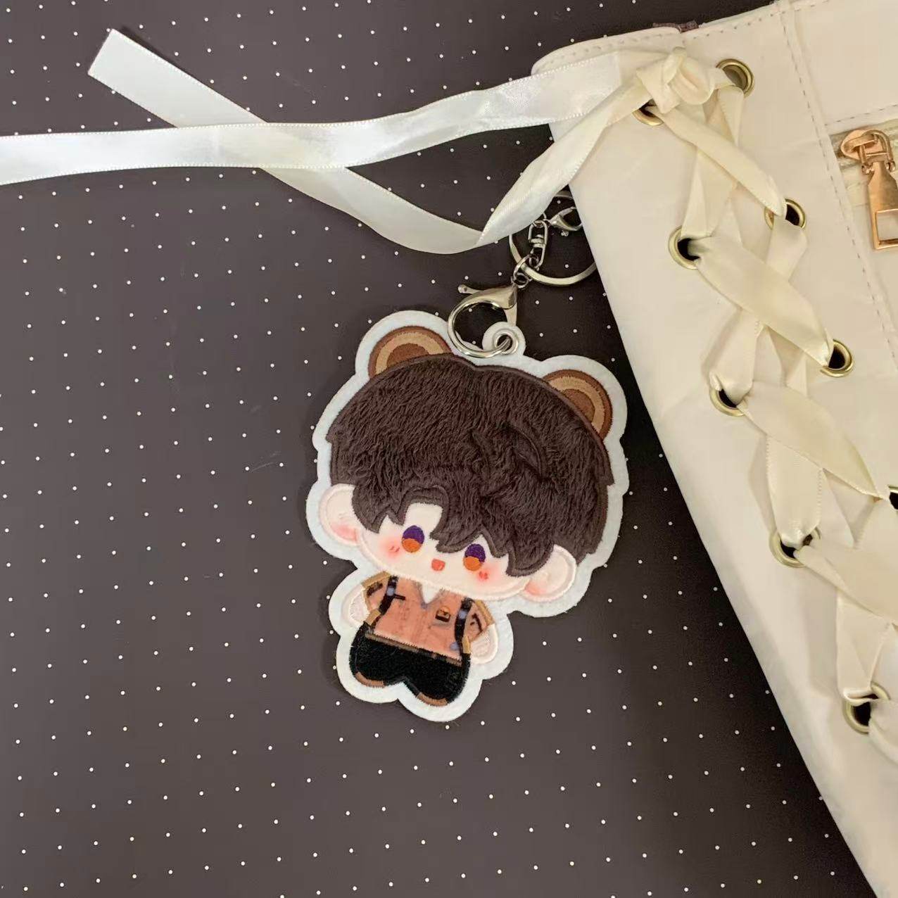 Fan-made Caleb embroidered plush charm attached to a bag