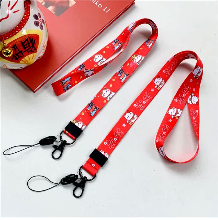 New Year Lucky Cat điện thoại dây buộc dây băng thông rộng nữ sáng tạo chủ chốt mặt dây chuyền chuỗi sling chiều dài phim hoạt hình màu đỏ chống mất - Phụ kiện điện thoại di động ốp lưng samsung j2