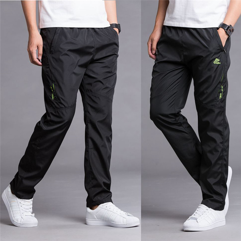 Mùa xuân và mùa hè quần thể thao quần tây nam quần polyester giản dị mùa đông cộng với nhung thoáng khí nhanh khô quần ống quần lỏng chạy quần jean nam hàng hiệu
