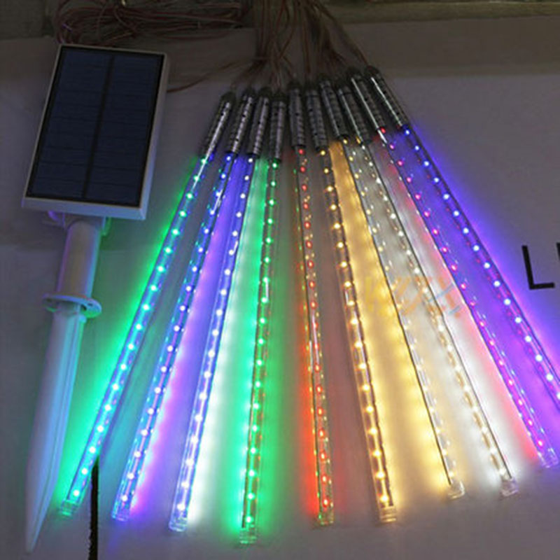 Solar LED colored meteor stream lights hang tree decorated with ten outdoor glowing plug water string