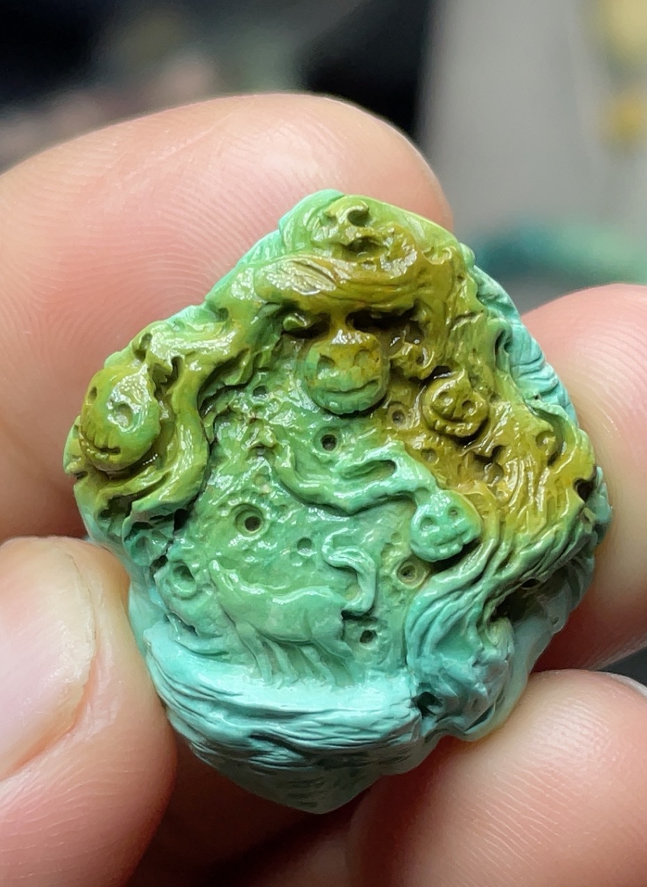 Turquoise playful craft carved death pendant...