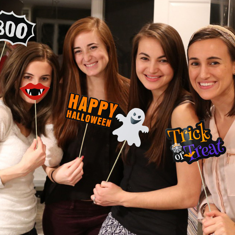 Halloween to blame for holding a paper photo-prop suit for an adult gathering party for a selfial photo of a skull mask