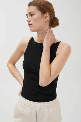 A simple and basic Nordic-style one-shoulder, boat-neck, sleeveless, halter top for women to wear over a flat-neck top