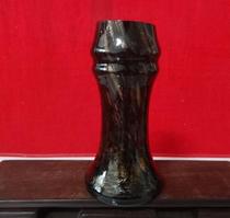 Old vase plugged in 1980s black gold glass bottles in nostalgia collection of movie props