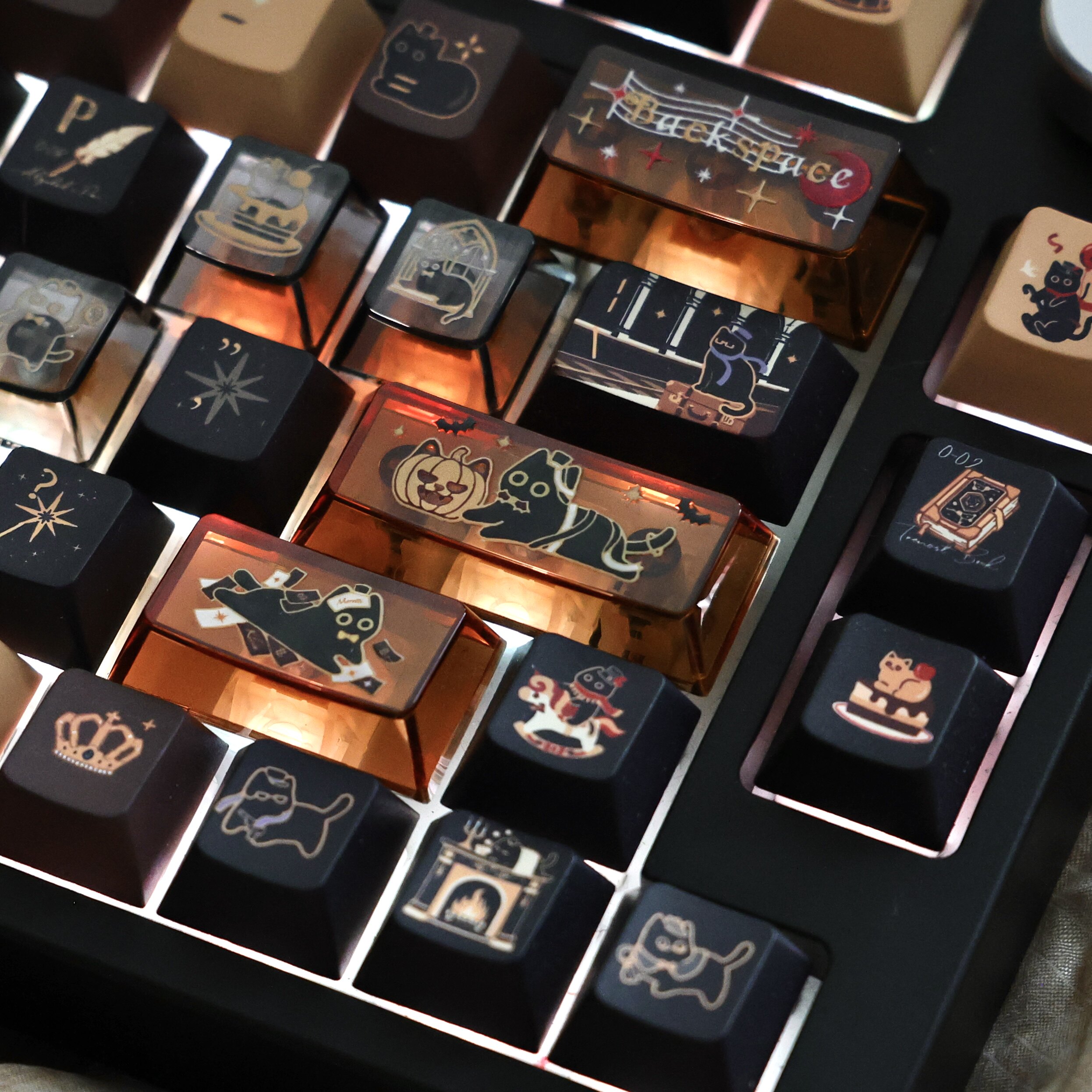 Close-up of illustrated transparent PC keycaps with amber backlighting