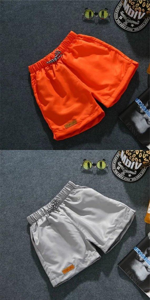 Quần short nam mùa hè chạy ba quần rộng quần lớn tinh thần xã hội quần bãi biển cặp vợ chồng ngủ nhà áo khoác nam