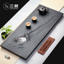 Sanxing hand carved natural black gold stone tea plate stone head tea table drainage household stone tea sea Simple tea sea