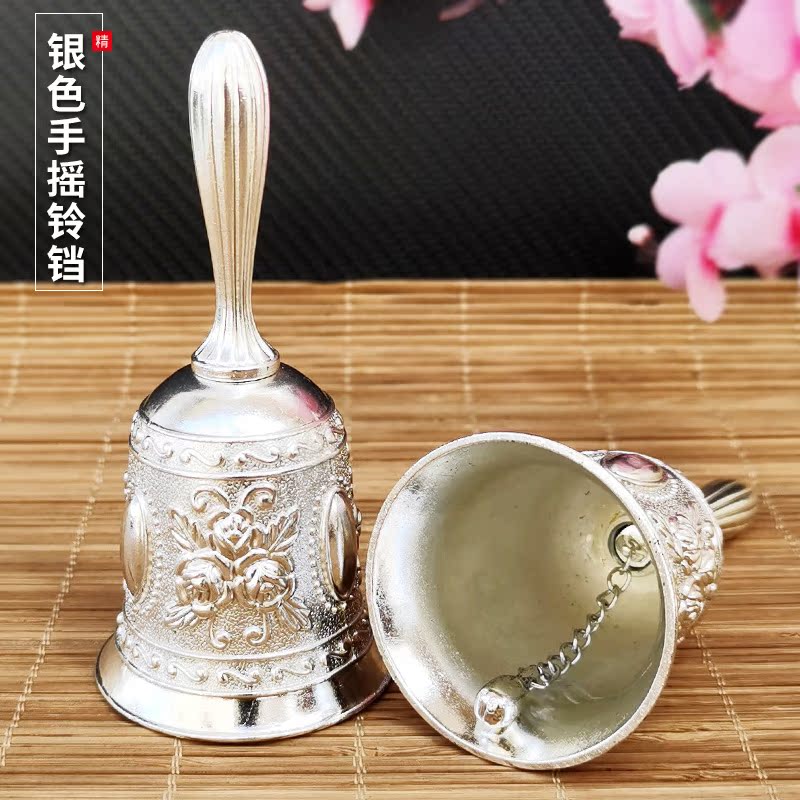 Silver hand-rocked metal bells kindergarten class manually ringing bells by old man's bed