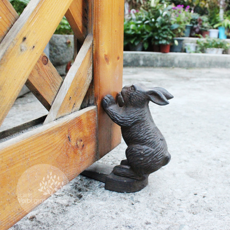 For example, the tree - outside the single cast iron old vintage cute rabbit puppy door blocking door wedge garden home American countryside