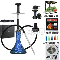 Полупрозрачная бутылка с синим рисунком и древесным углем из скорлупы кокосового ореха.