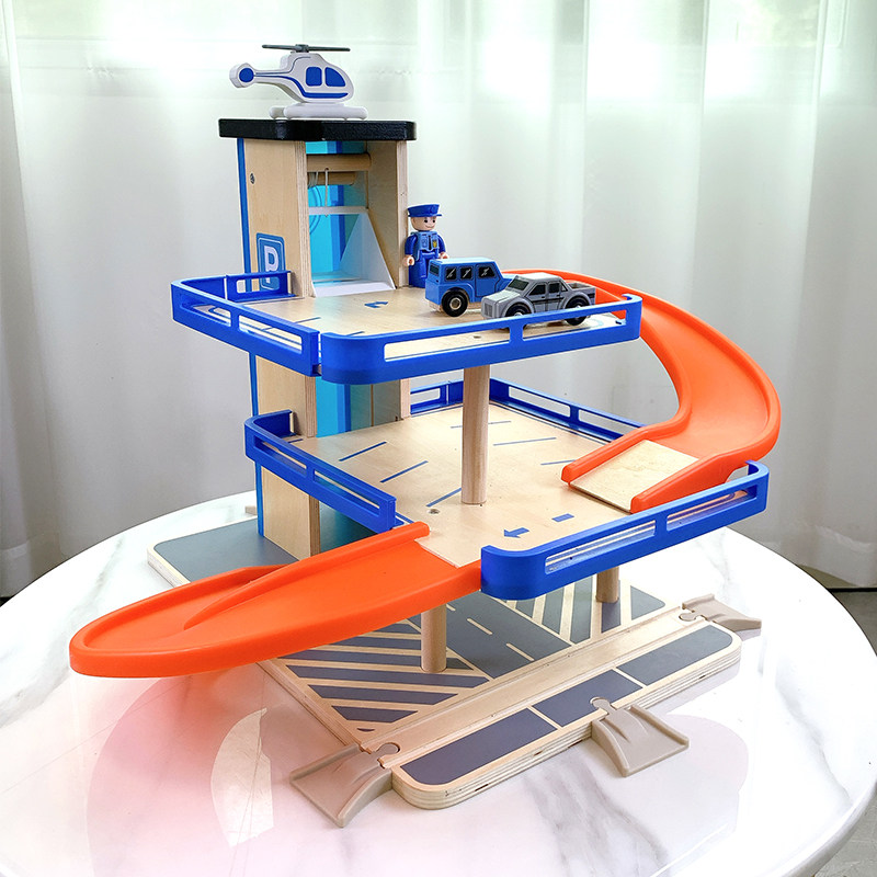 Boy assembles rotating track toy parking lot model children's sliding car set simulation puzzle 3 years old