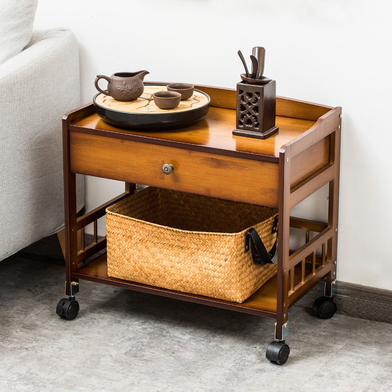 A few small tea tables on the side of the couch with a few tea tables on the sideroom tea cabinet with wheel