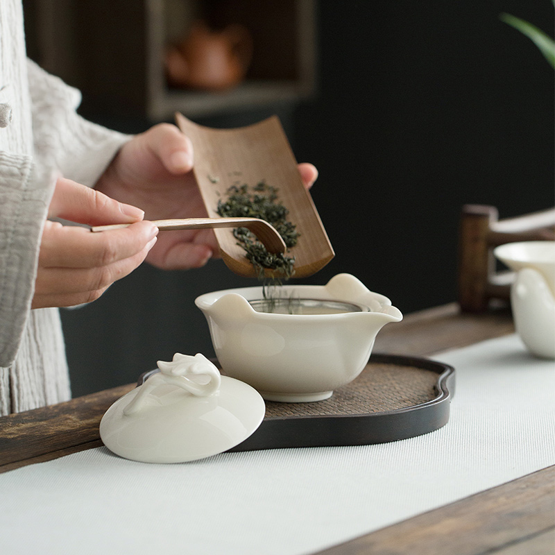 Dehua lard white porcelain hand grasp pot of ceramic kung fu tea tureen filter to use cups with three bowls of household