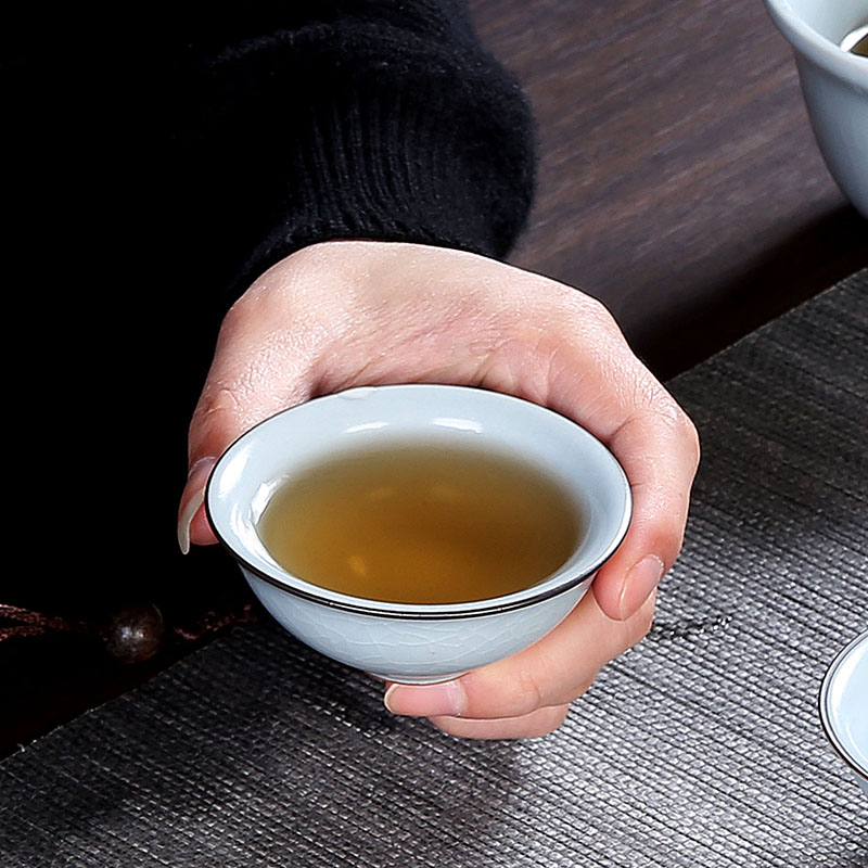 Crack cup against a pot of three cups of hot ceramics glass portable travel kung fu tea set contracted