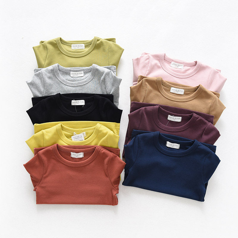 Sơn Đông cửa hàng quần áo trẻ em cửa hàng quần áo trẻ em cotton đáy quần áo trẻ em lớn tay áo thun dài tay màu kẹo áo thun bé trai