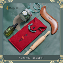 Large S-shaped pumice stone scraping board with hand containing wormwood essential oil Pepper Wood