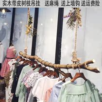 Clothing store hemp rope hanging rod original solid wooden stick with Pison dry branches window men and women are hanging clothes sideways display