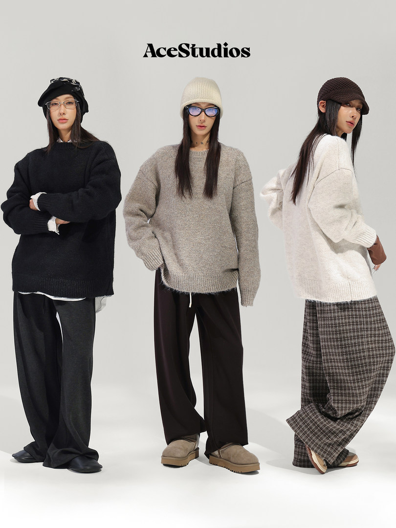 Three models wearing cozy knit sweaters, hats, and relaxed wide-leg pants.