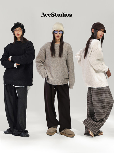 Three models wearing cozy knit sweaters, hats, and relaxed wide-leg pants.