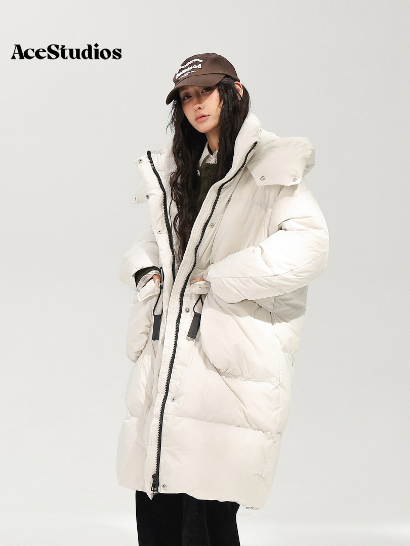Model wearing a white oversized puffer coat with hood
