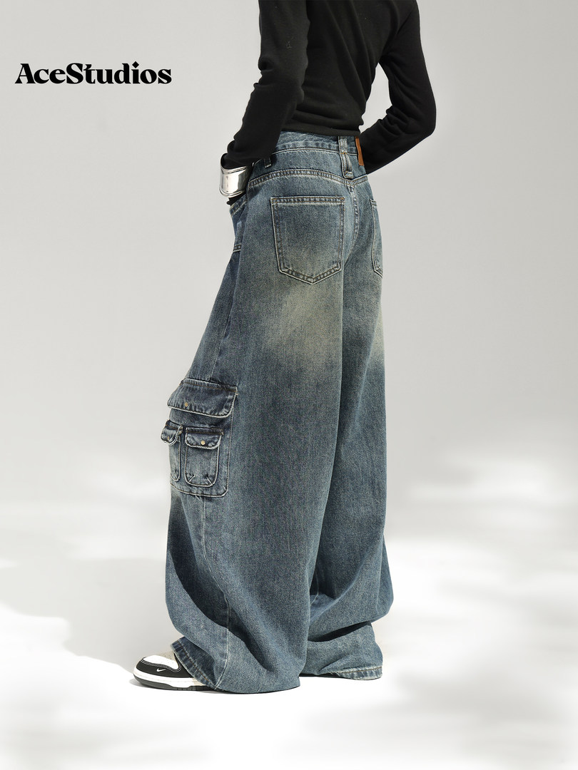 Model wearing oversized blue cargo jeans with a black top