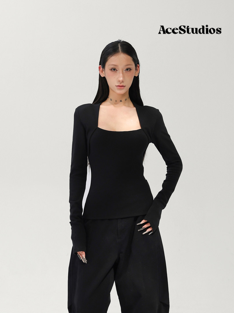 Model wearing a black long-sleeve fitted top with black pants