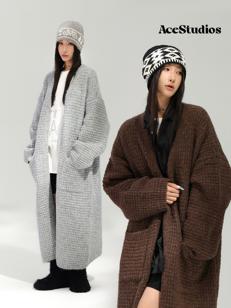 Two models wearing oversized knitted cardigans and patterned knit beanies