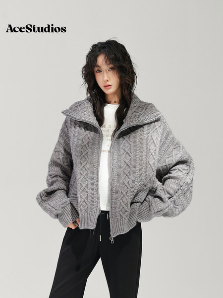 Model wearing a gray textured zip-up jacket with black pants