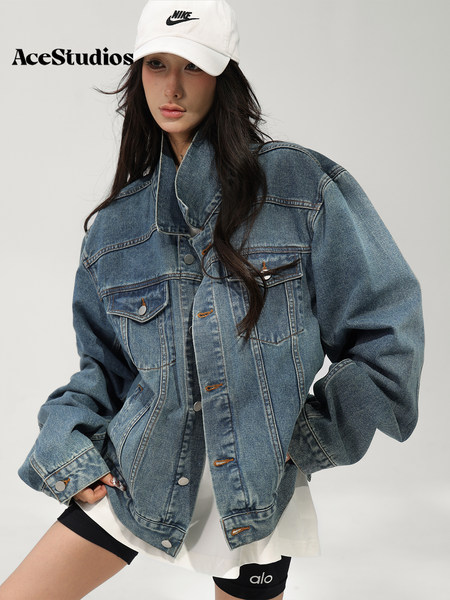 Model wearing an oversized blue denim jacket with a white cap and athletic shorts